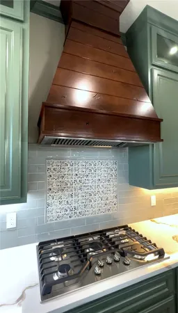 a stove top oven sitting inside of a kitchen