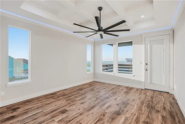 a view of a big room with wooden floor and a ceiling fan