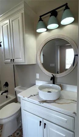 a bathroom with a toilet a sink and bathtub