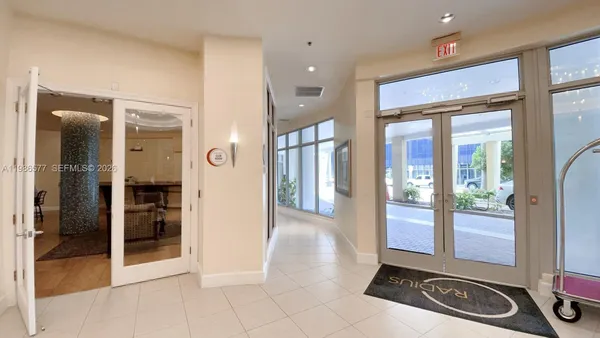 a view of kitchen with stainless steel appliances kitchen island granite countertop dining table chairs and a glass door
