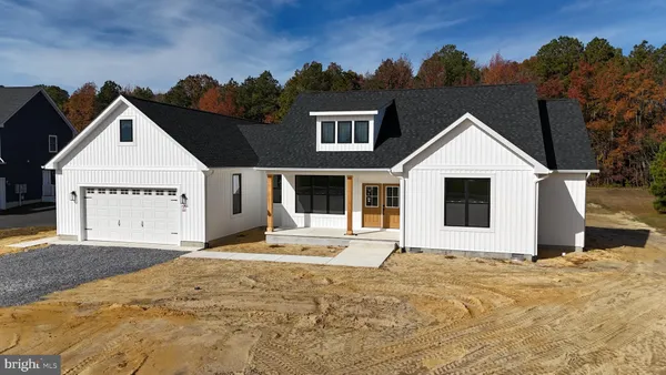 a view of a white house with a yard
