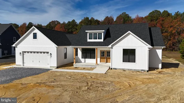 a view of a white house with a yard