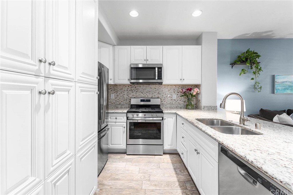 83 Chadron Circle Ladera Ranch, CA 92694 - Photo 1 of 1 a kitchen with granite countertop a sink stainless steel appliances and white cabinets