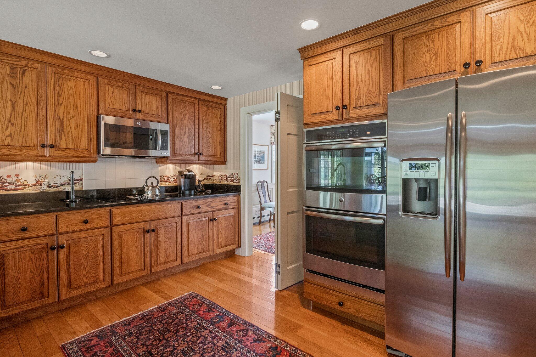 137 Strong Island Road Chatham, MA 02633 - Photo 12 of 37 a kitchen with granite countertop stainless steel appliances and wooden cabinets