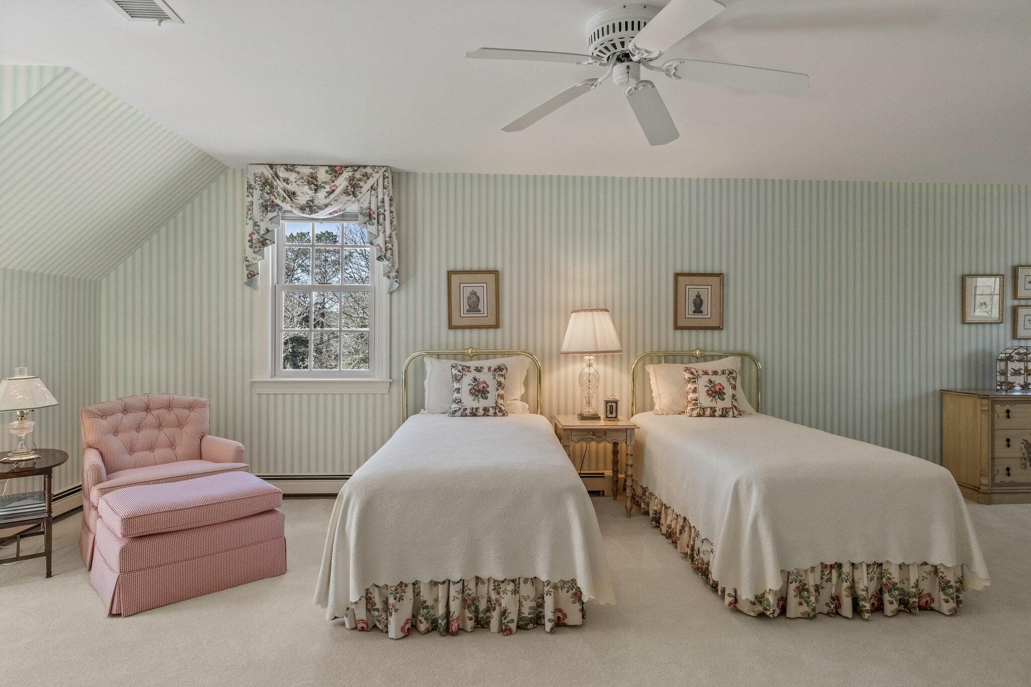 137 Strong Island Road Chatham, MA 02633 - Photo 24 of 37 a bedroom with two beds and a chandelier