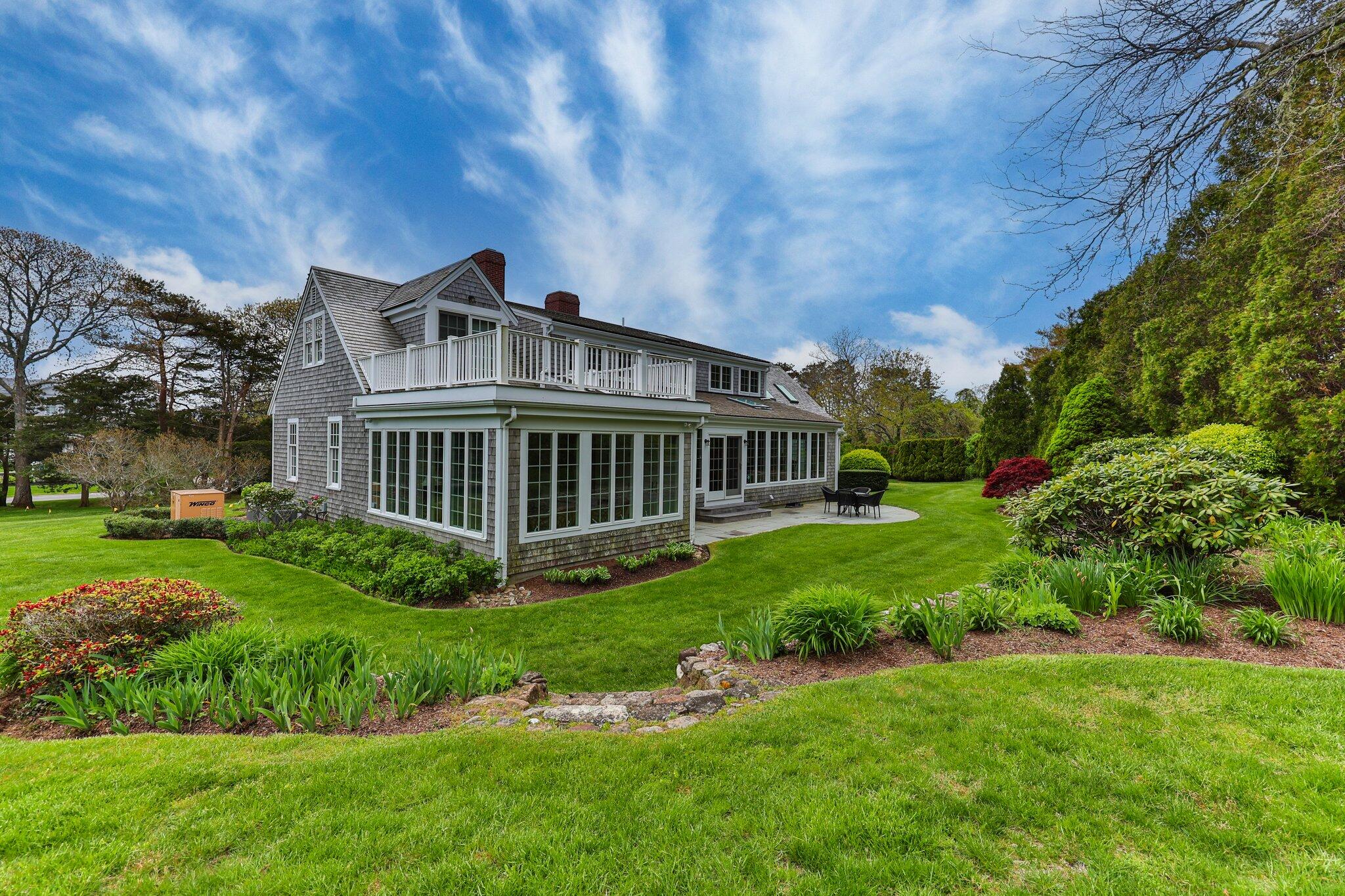 137 Strong Island Road Chatham, MA 02633 - Photo 35 of 37 a view of a house with a big yard potted plants and large tree