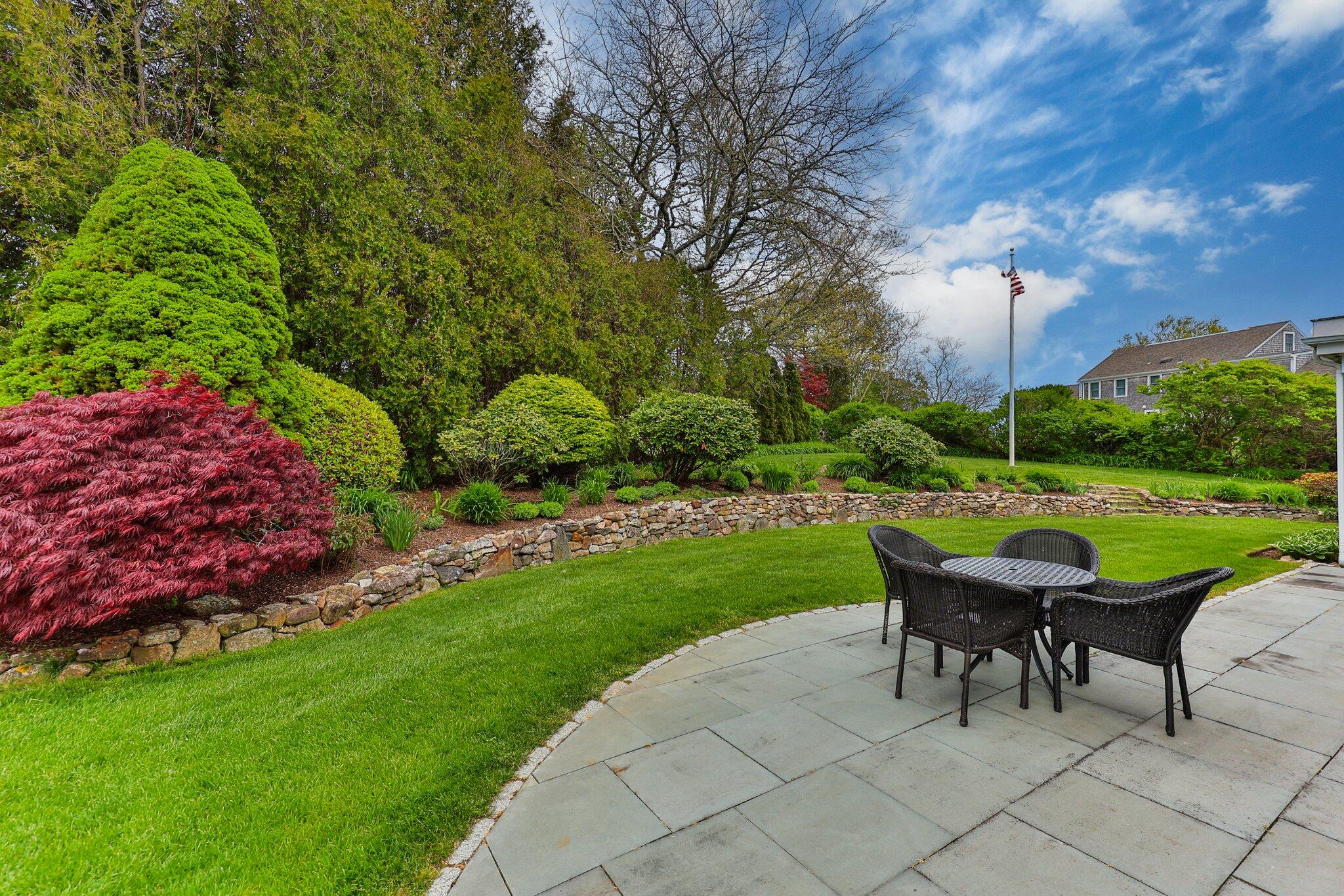 137 Strong Island Road Chatham, MA 02633 - Photo 36 of 37 a view of a table and chairs in backyard of the house