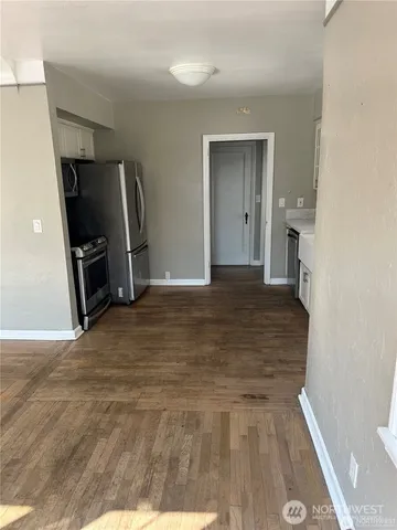 a kitchen with granite countertop white cabinets and white appliances