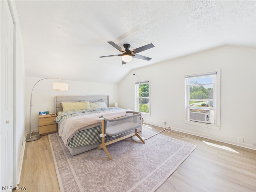 3490 County Line Road Madison, OH 44057 - Photo 10 of 42 Spacious room featuring vaulted ceilings, wood-finish flooring, and a contemporary ceiling fan