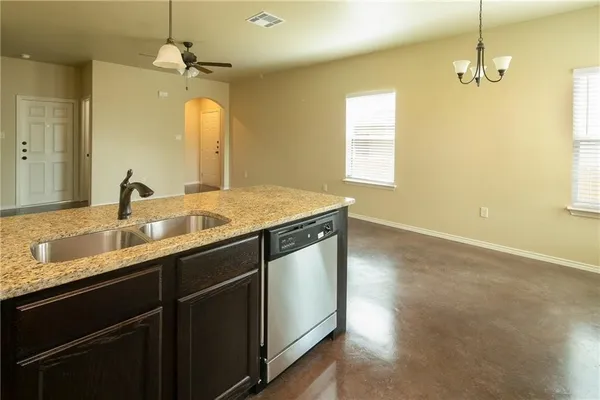 a bathroom with a granite countertop sink a large mirror and vanity