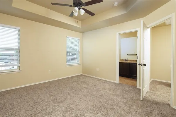 an empty room with a ceiling fan and a window