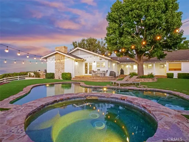 a aerial view of a house with table and chairs and a yard