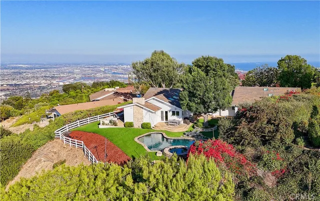 a kitchen with a table chairs and a chandelier