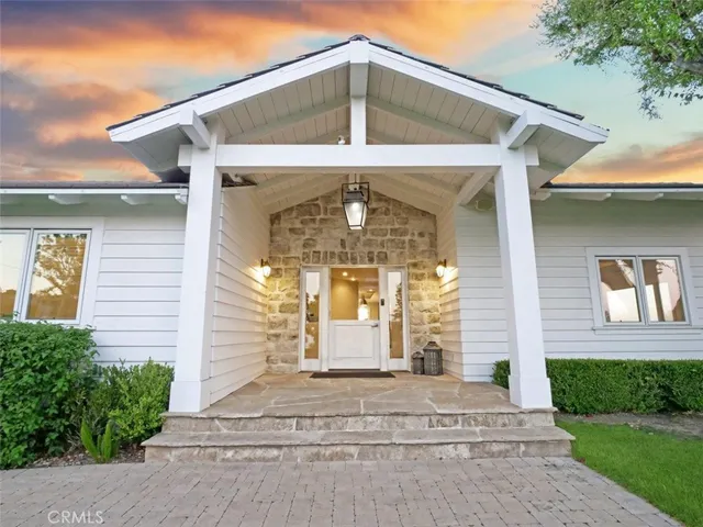 a kitchen with a sink a counter and chairs