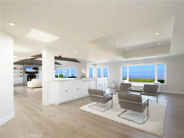 a view of a yard with plants and a large tree