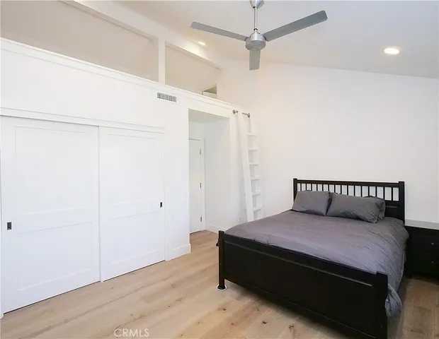a bedroom with a bed and a walk in closet
