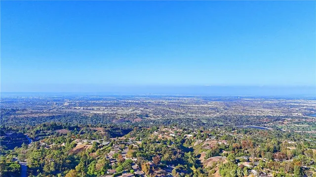 a aerial view of a house with swimming pool garden and lake view
