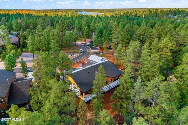 an aerial view of a house with a yard