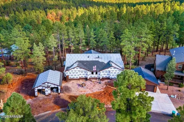 an aerial view of a house with yard swimming pool and outdoor seating