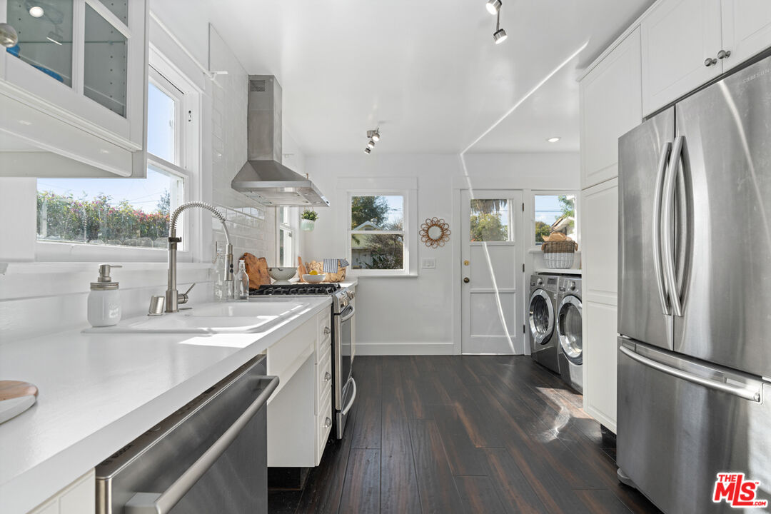 743 Sunset Avenue Venice, CA 90291 - Photo 4 of 29 a kitchen with a sink a refrigerator and wooden floor
