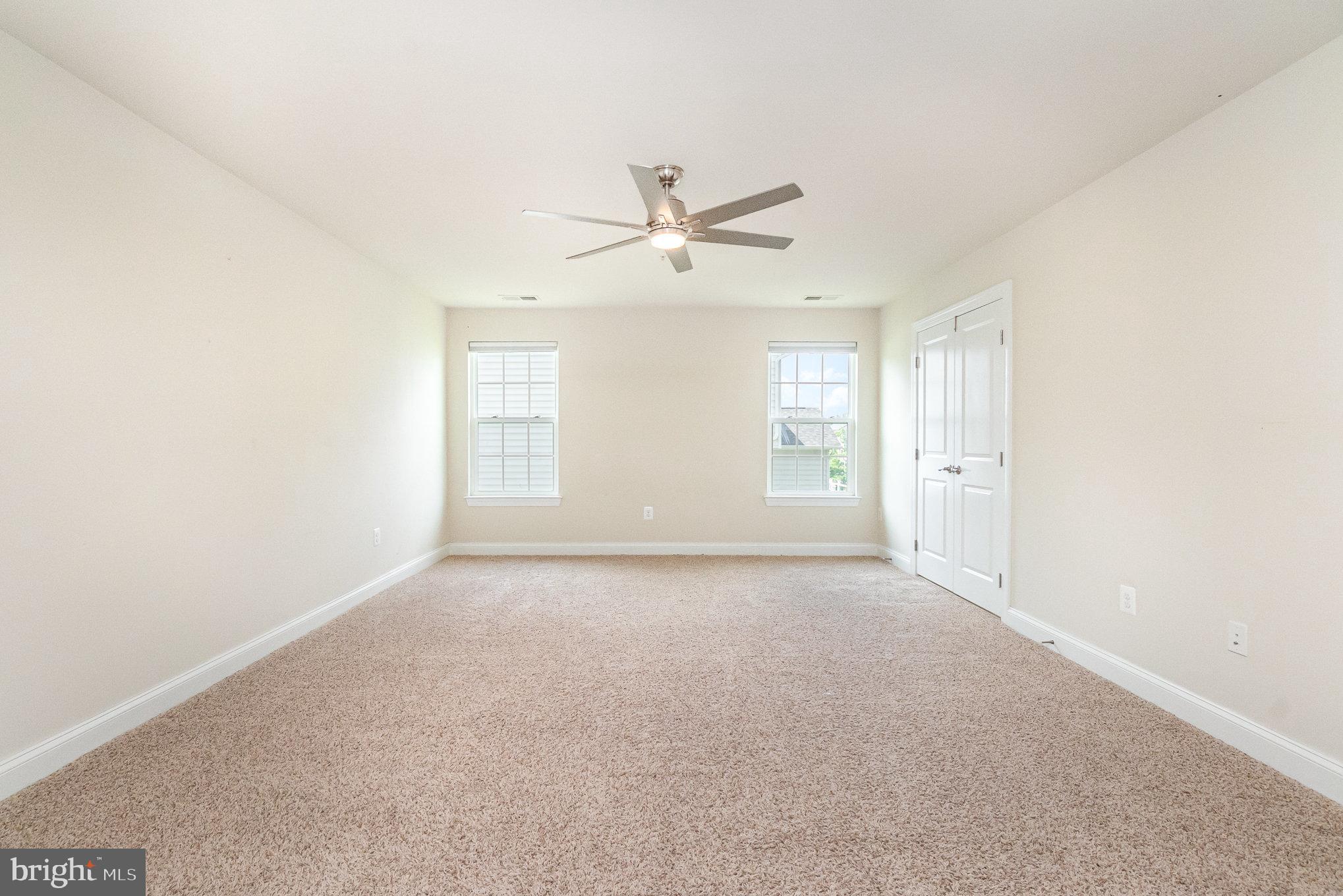 10535 Windlass Run Road Baltimore, MD 21220 - Photo 22 of 42 an empty room with windows and fan