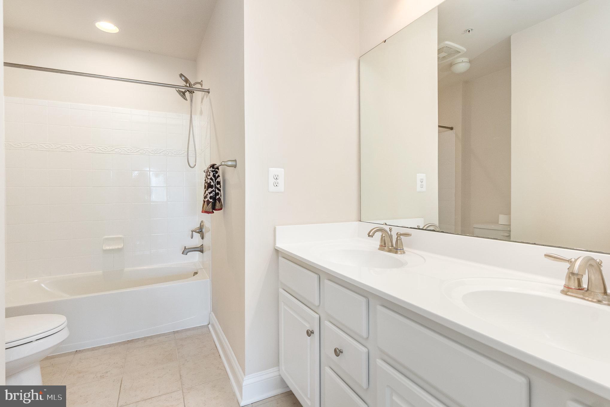10535 Windlass Run Road Baltimore, MD 21220 - Photo 25 of 42 a bathroom with a granite countertop sink toilet and shower