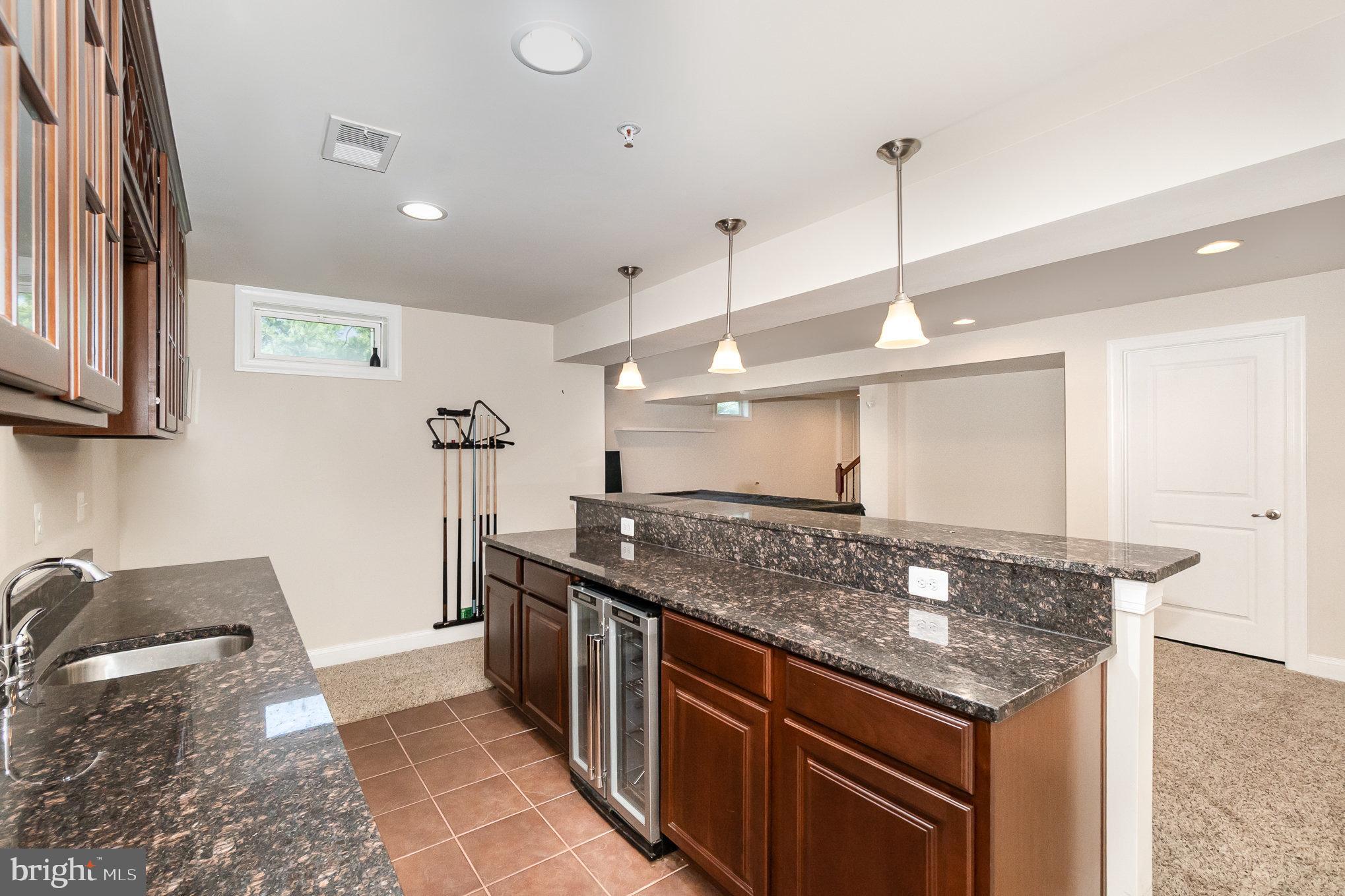 10535 Windlass Run Road Baltimore, MD 21220 - Photo 32 of 42 a kitchen with stainless steel appliances granite countertop a sink and a stove