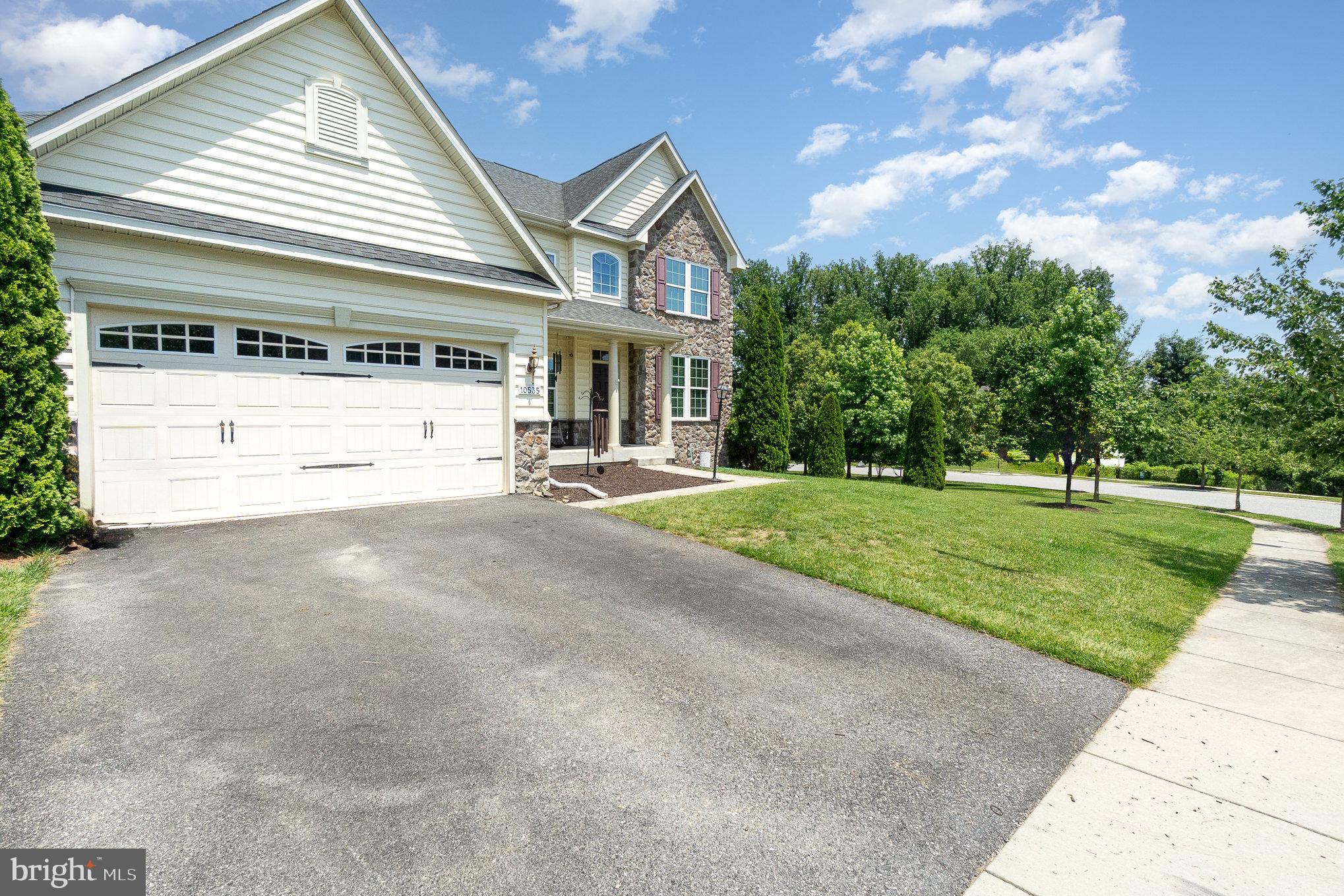 10535 Windlass Run Road Baltimore, MD 21220 - Photo 4 of 42 a front view of a house with a garden and trees
