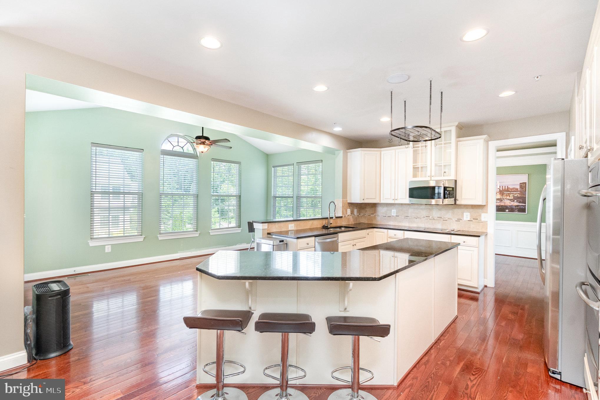 10535 Windlass Run Road Baltimore, MD 21220 - Photo 5 of 42 a dining table with wooden floor and kitchen view