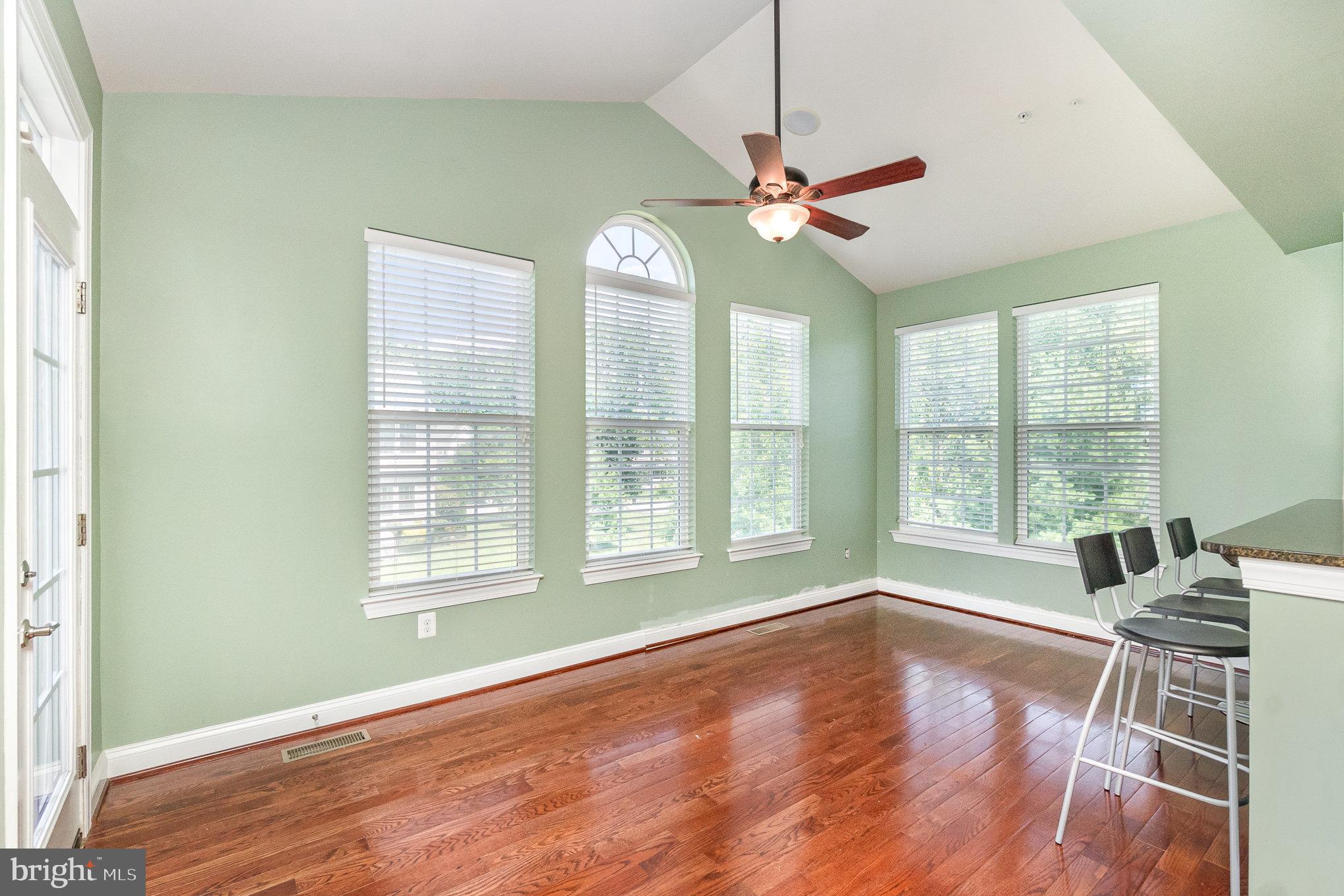 10535 Windlass Run Road Baltimore, MD 21220 - Photo 9 of 42 a view of an empty room with wooden floor and a window