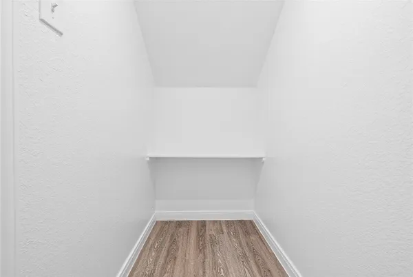 a view of room with wooden floor