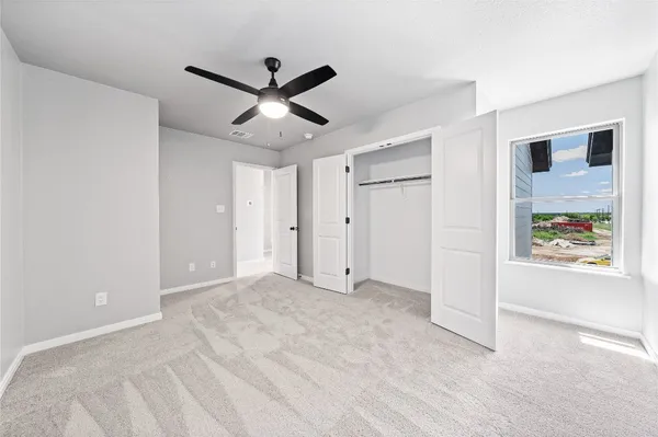 a view of a livingroom with a ceiling fan and window
