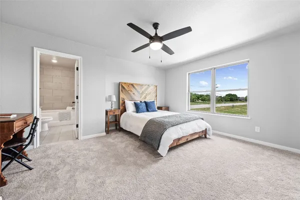 a bedroom with a bed and large window