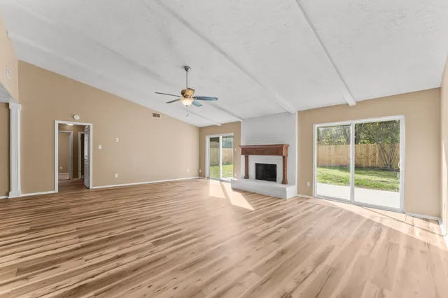 a large white kitchen with kitchen island a sink stainless steel appliances and cabinets
