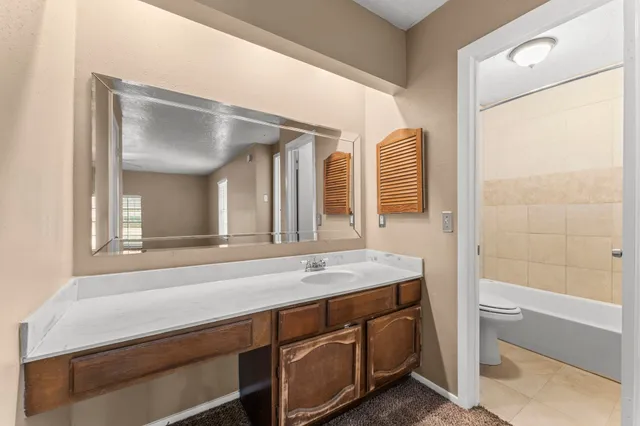 a bathroom with a sink a toilet and bathtub