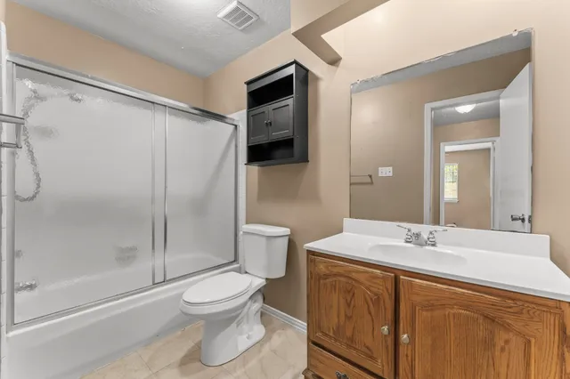 an empty room with fan and windows