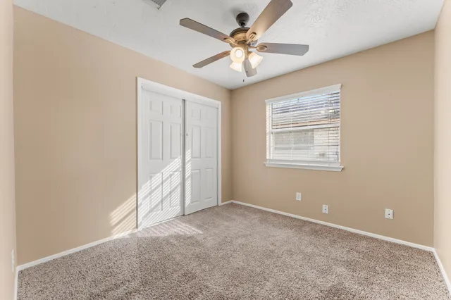 a view of room with window and ceiling fan