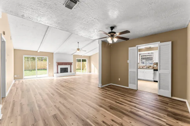 a view of a room with wooden floor