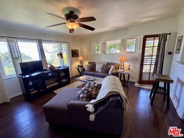 a living room with furniture rug and wooden floor