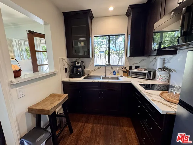 a kitchen with a sink cabinets and window