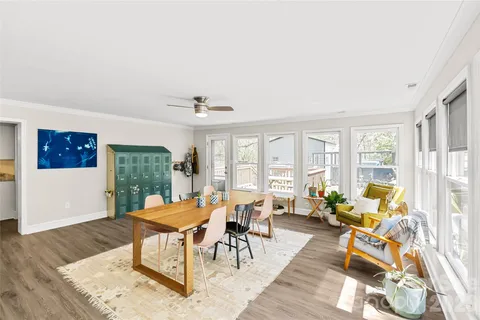 a living room with furniture and floor to ceiling windows