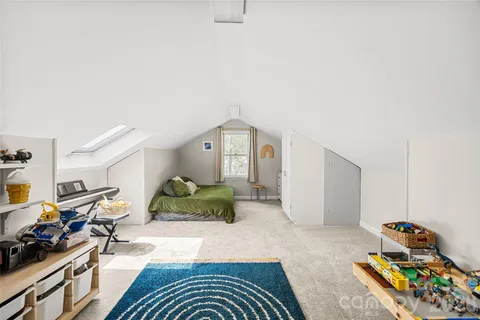 a bedroom with furniture and a wooden floor