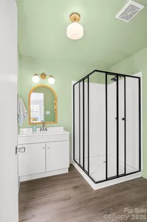 a spacious bathroom with a mirror and a sink