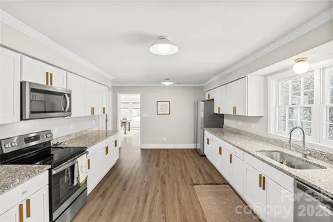 a kitchen with stainless steel appliances granite countertop a stove and a sink