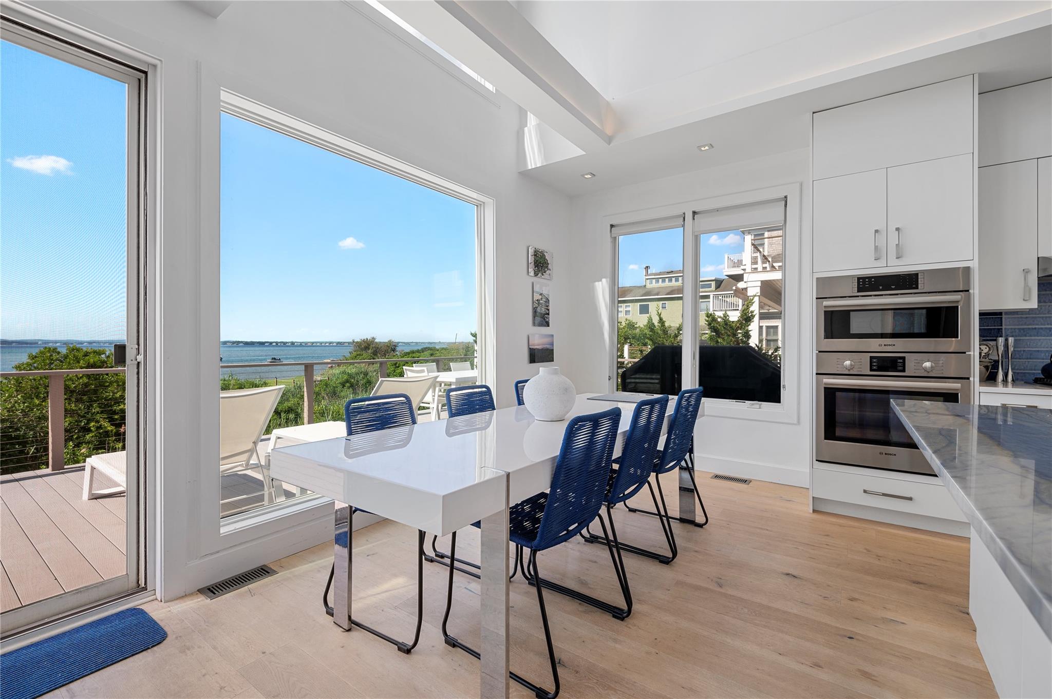 846 Dune Road West Hampton Dunes, NY 11978 - Photo 11 of 49 a view of a dining room with furniture window and wooden floor
