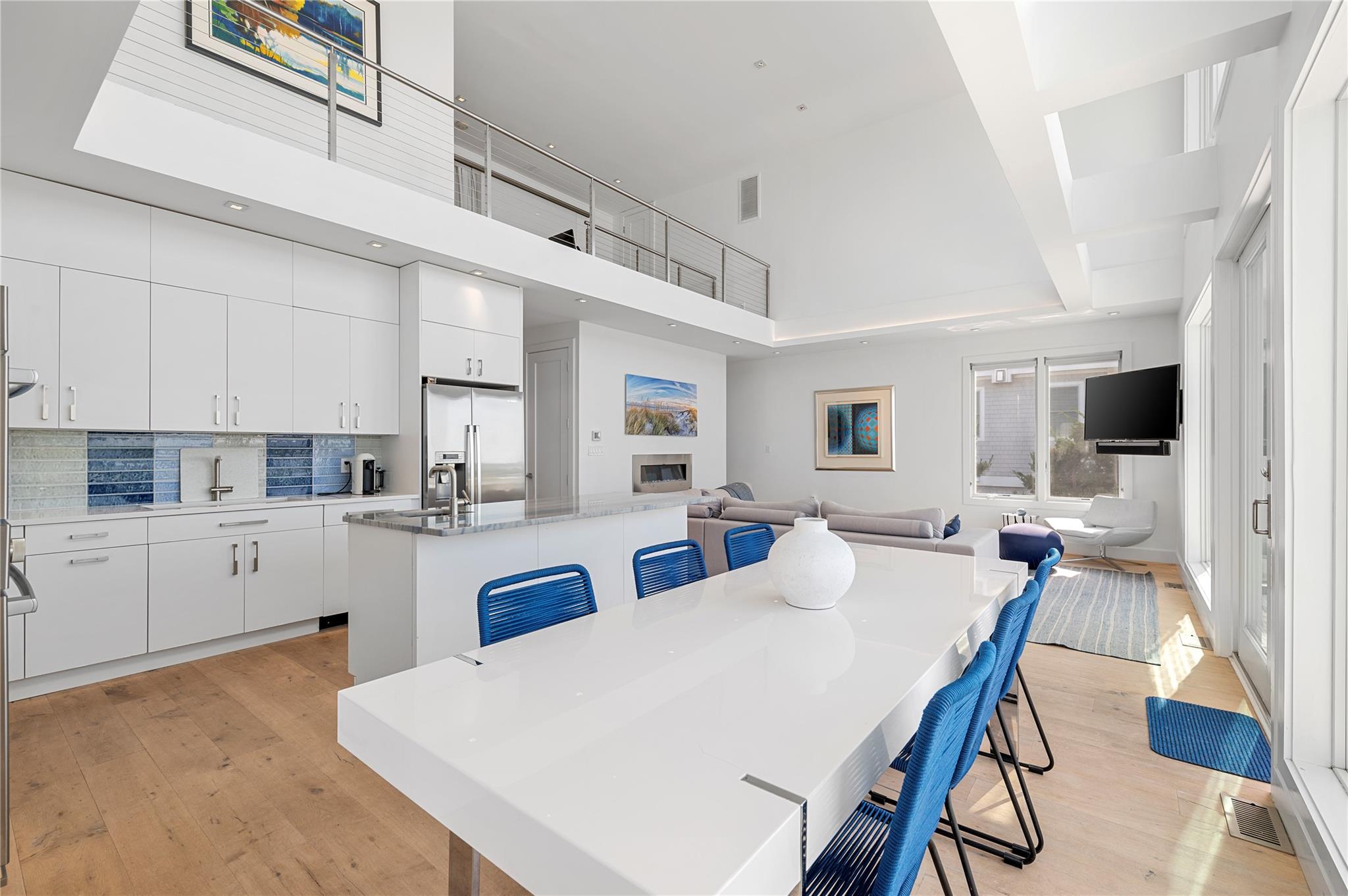 846 Dune Road West Hampton Dunes, NY 11978 - Photo 12 of 49 a large kitchen with kitchen island a dining table and chairs