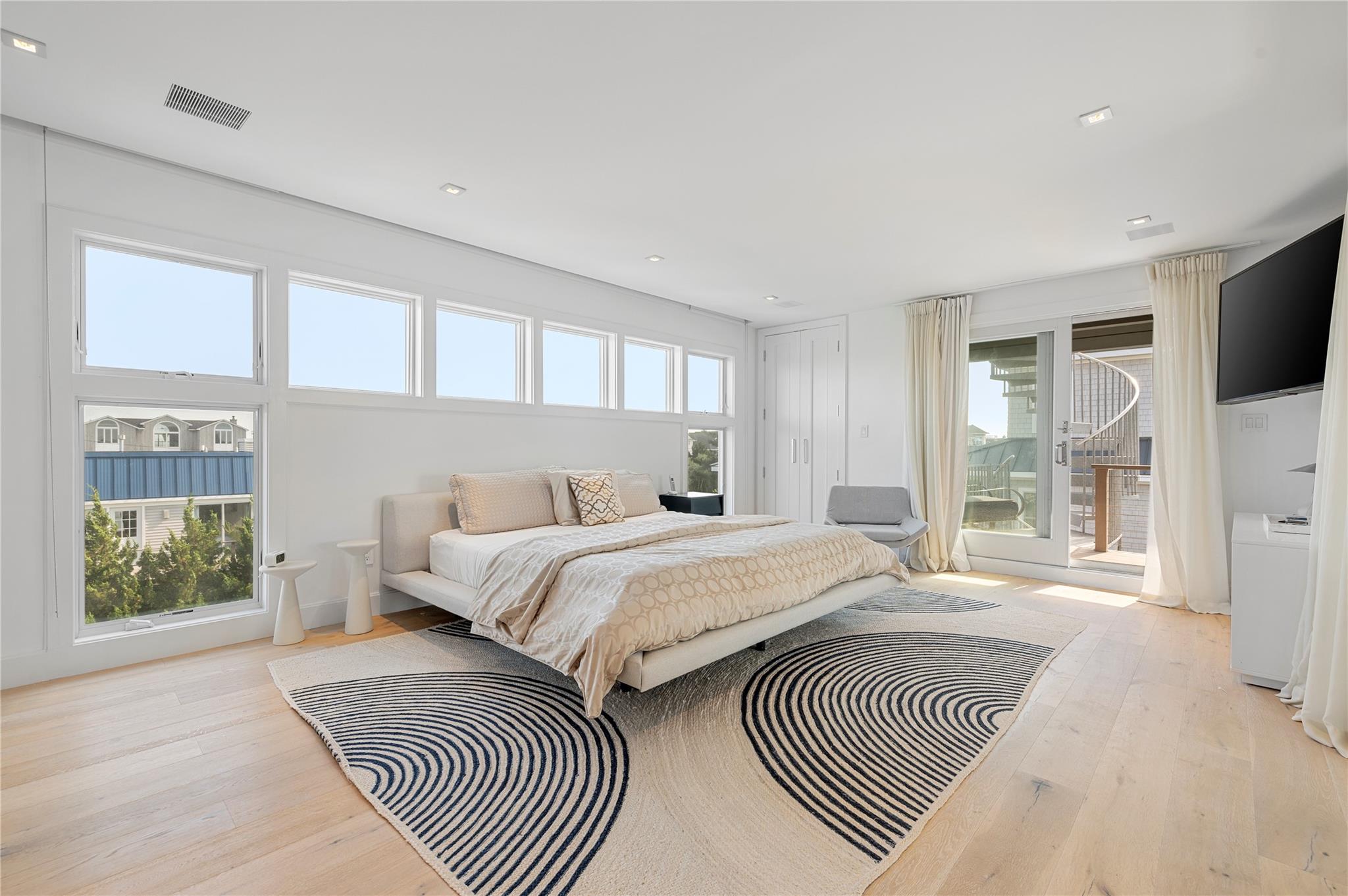 846 Dune Road West Hampton Dunes, NY 11978 - Photo 15 of 49 a bedroom with a large bed and a window