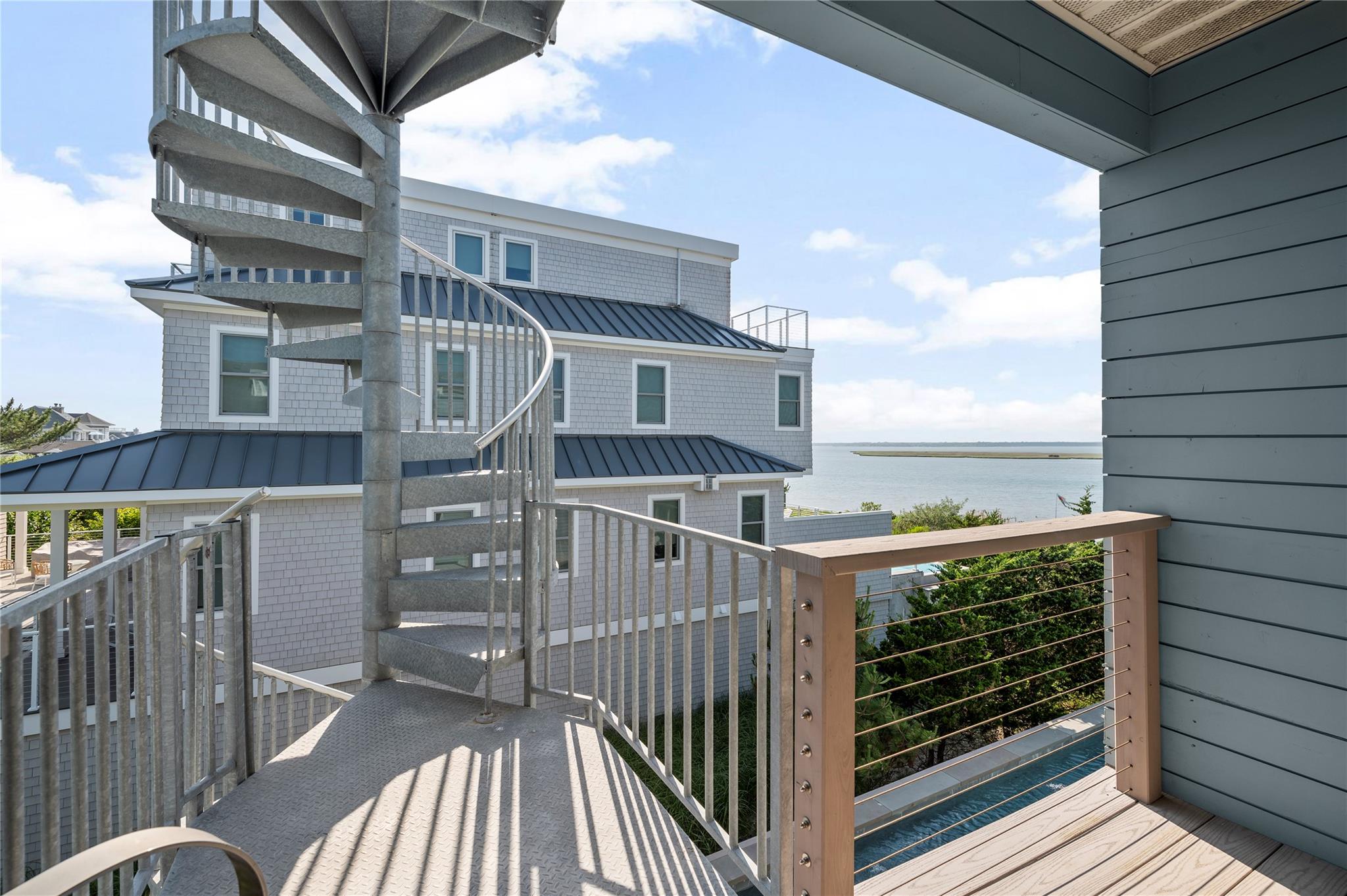 846 Dune Road West Hampton Dunes, NY 11978 - Photo 19 of 49 a view of a balcony with wooden floor and fence