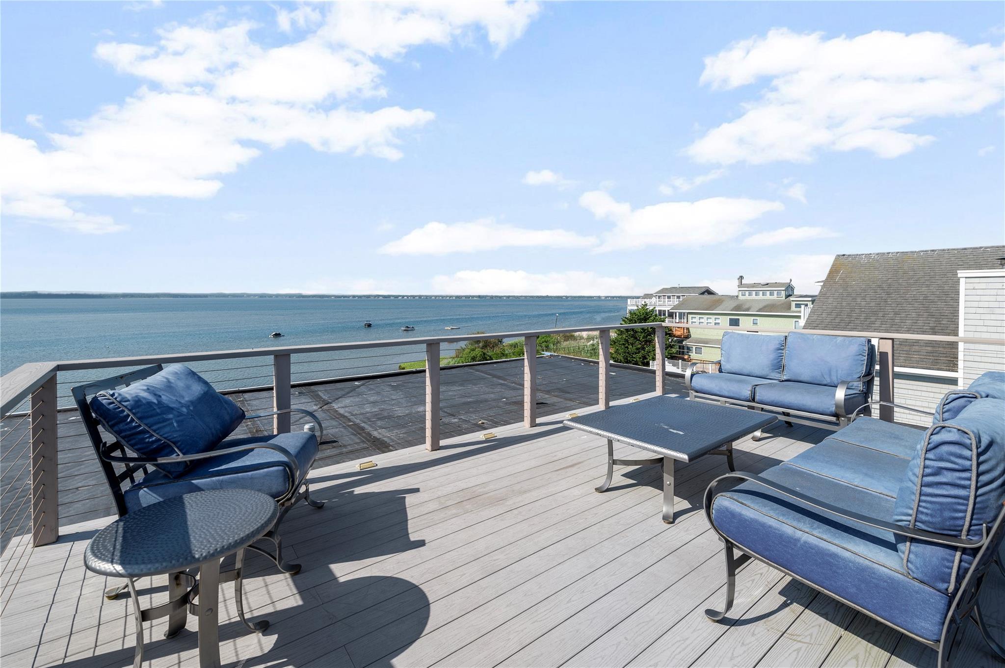 846 Dune Road West Hampton Dunes, NY 11978 - Photo 21 of 49 a roof deck with outdoor seating and city view