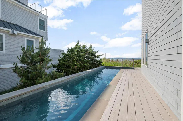 a roof deck with outdoor seating and city view